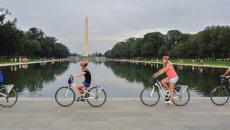 People biking past the Washington Monument on a tour with Bike & Roll in Washington, DC, USA