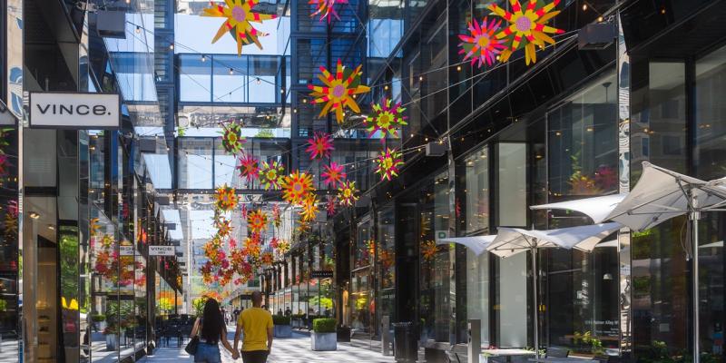 A couple walk past the stores at CityCenterDC