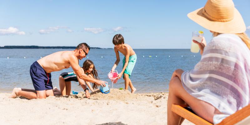 A family builds a sand castle on a beach in Jamestown and Yorktown, Virginia, USA.