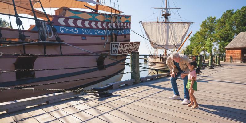 A kid and parent marvel at the hull of historical 17th-century ships in Jamestown Settlement, Virginia, USA