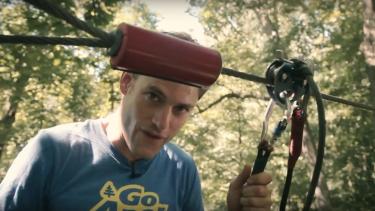 A man preparing to slide down a zipline