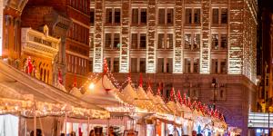 People walking through the outdoor market at night