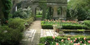 A garden with walkways and tulips blooming