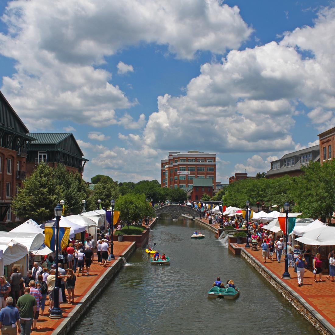 Festival tents along each side of the creek in downtown Frederick