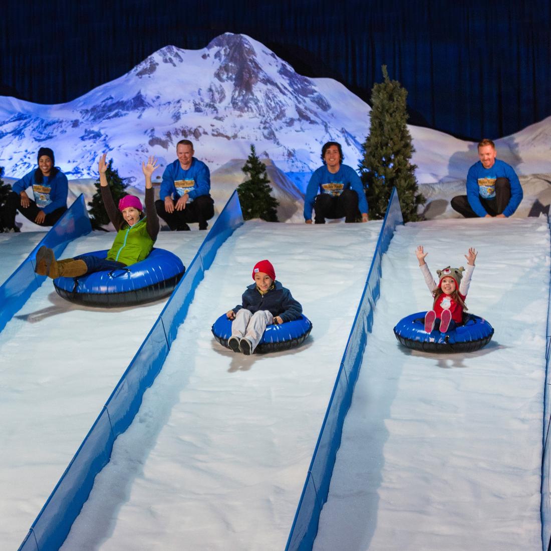 People snow tubing indoors at ICE!