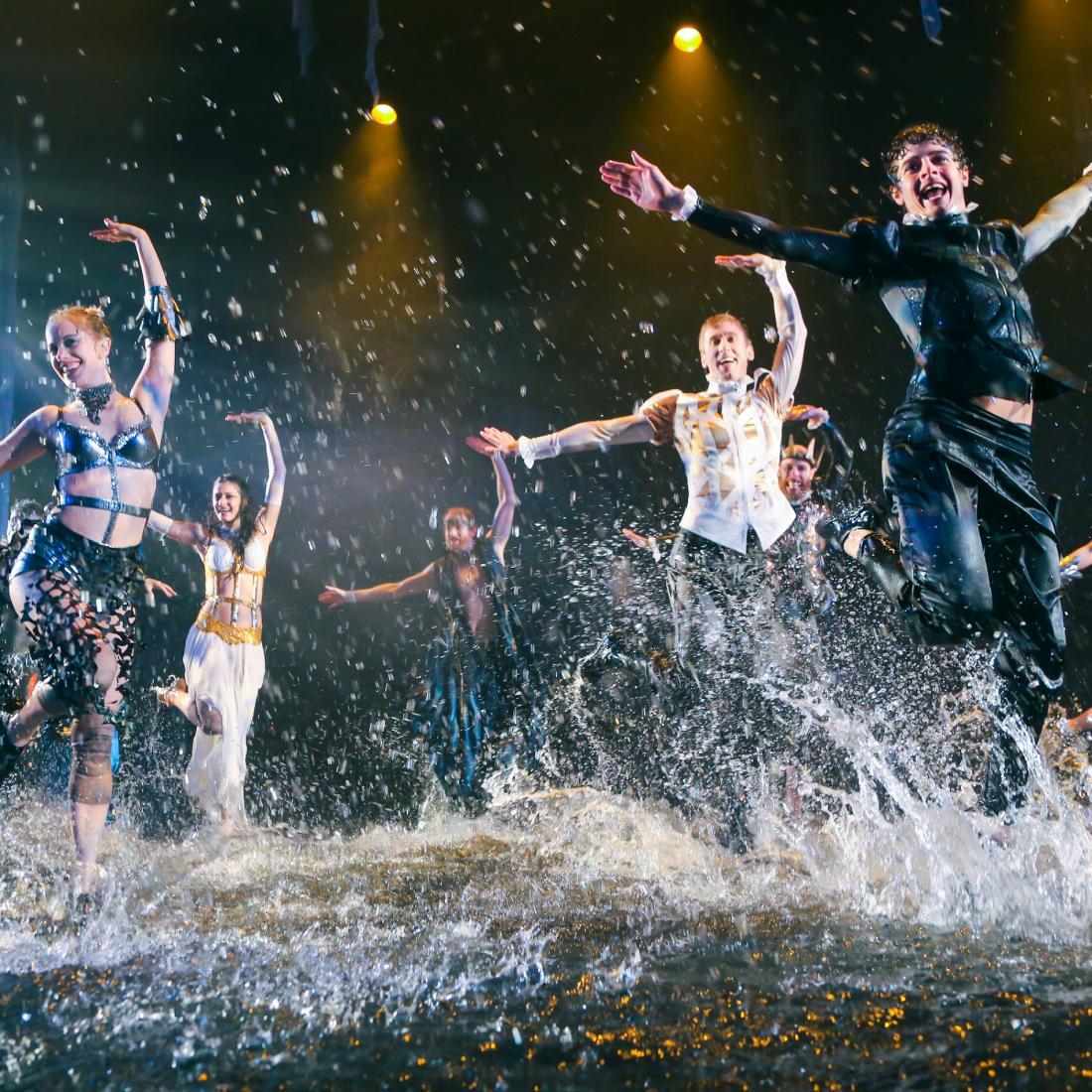 Dancers perform in splashing water