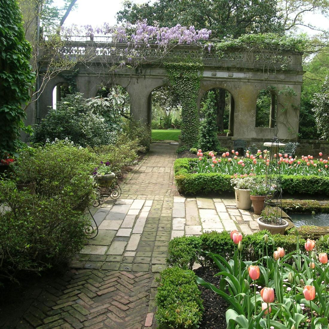 A garden with walkways and tulips blooming