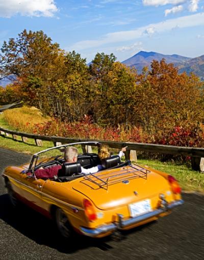 A convertible drives along the Blue Ridge Parkway in Virginia, USA.
